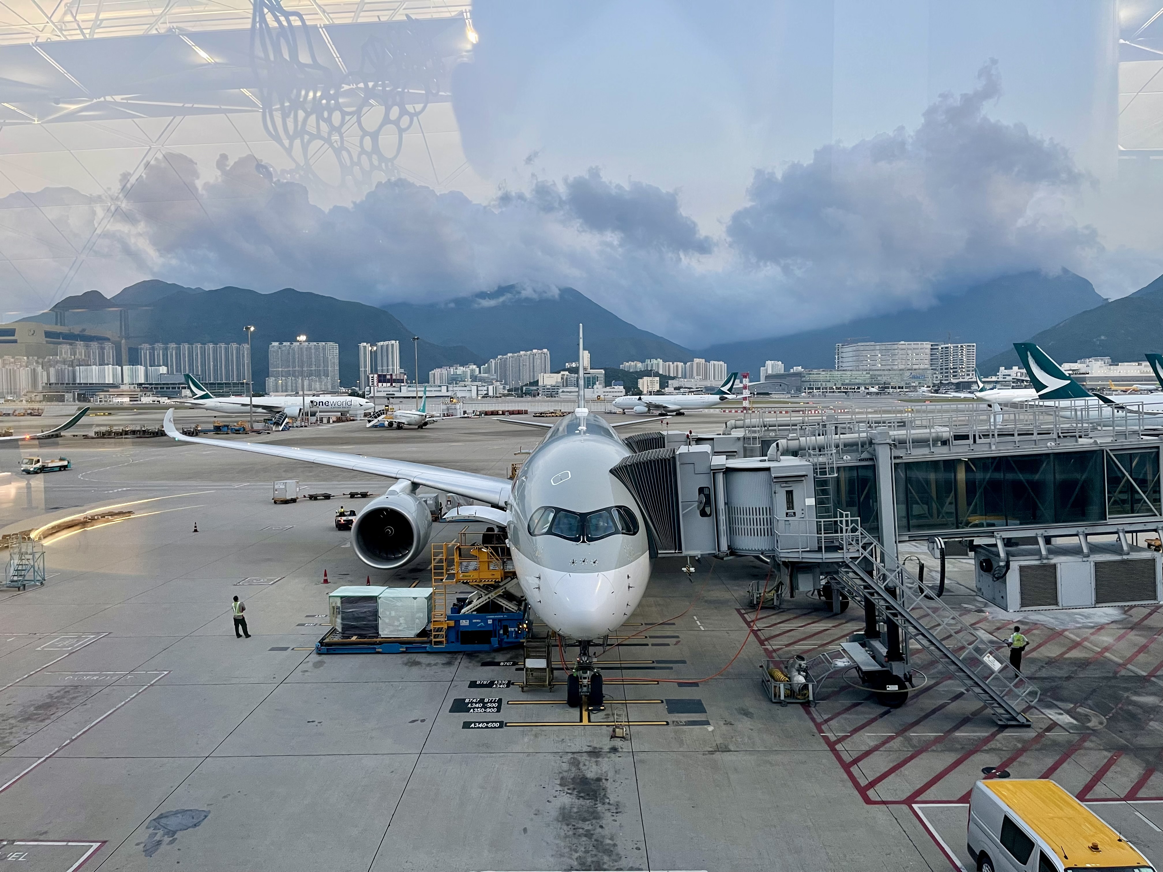 Masked up, looking out the window at my airplane at HKG