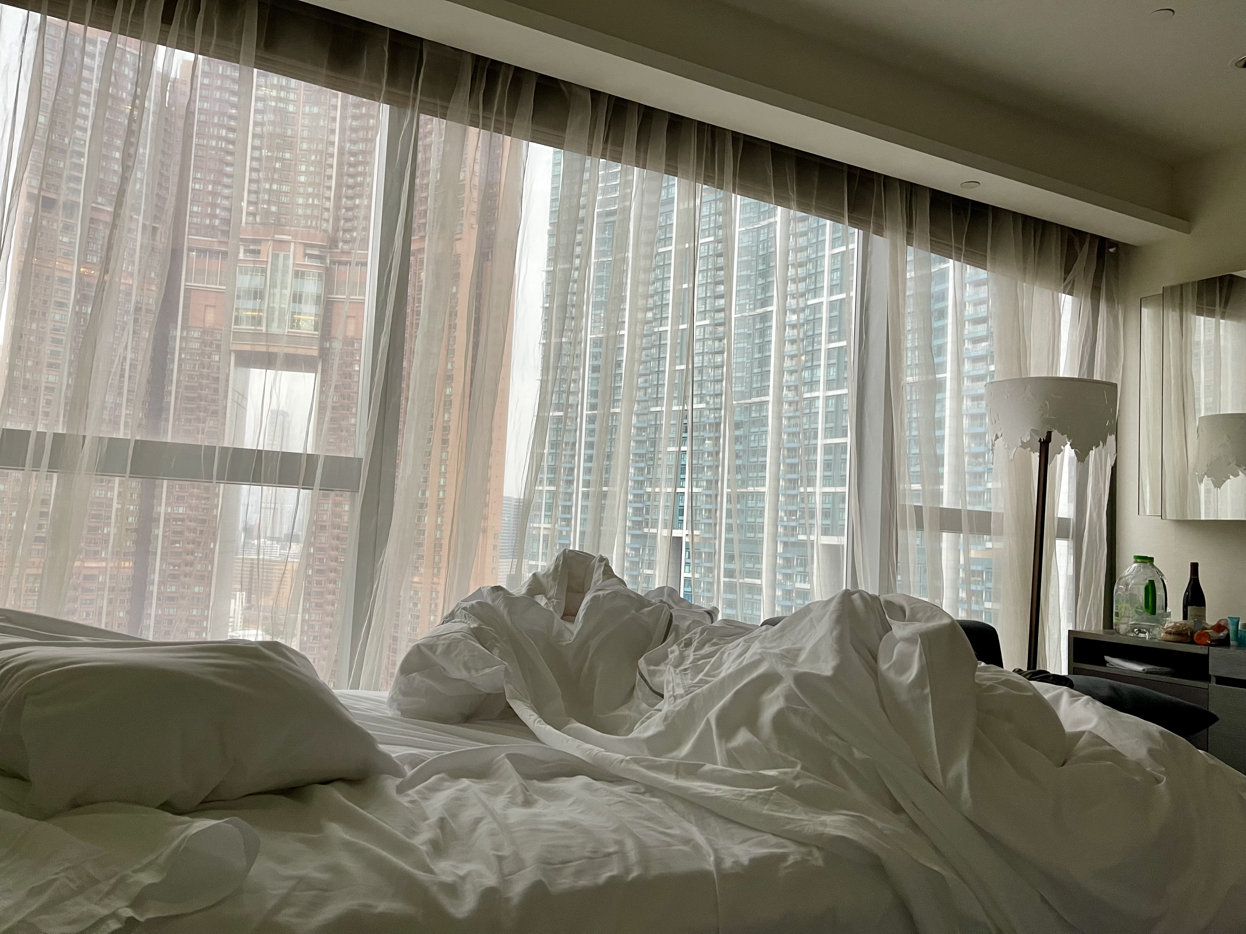 Hotel bed and towers beyond