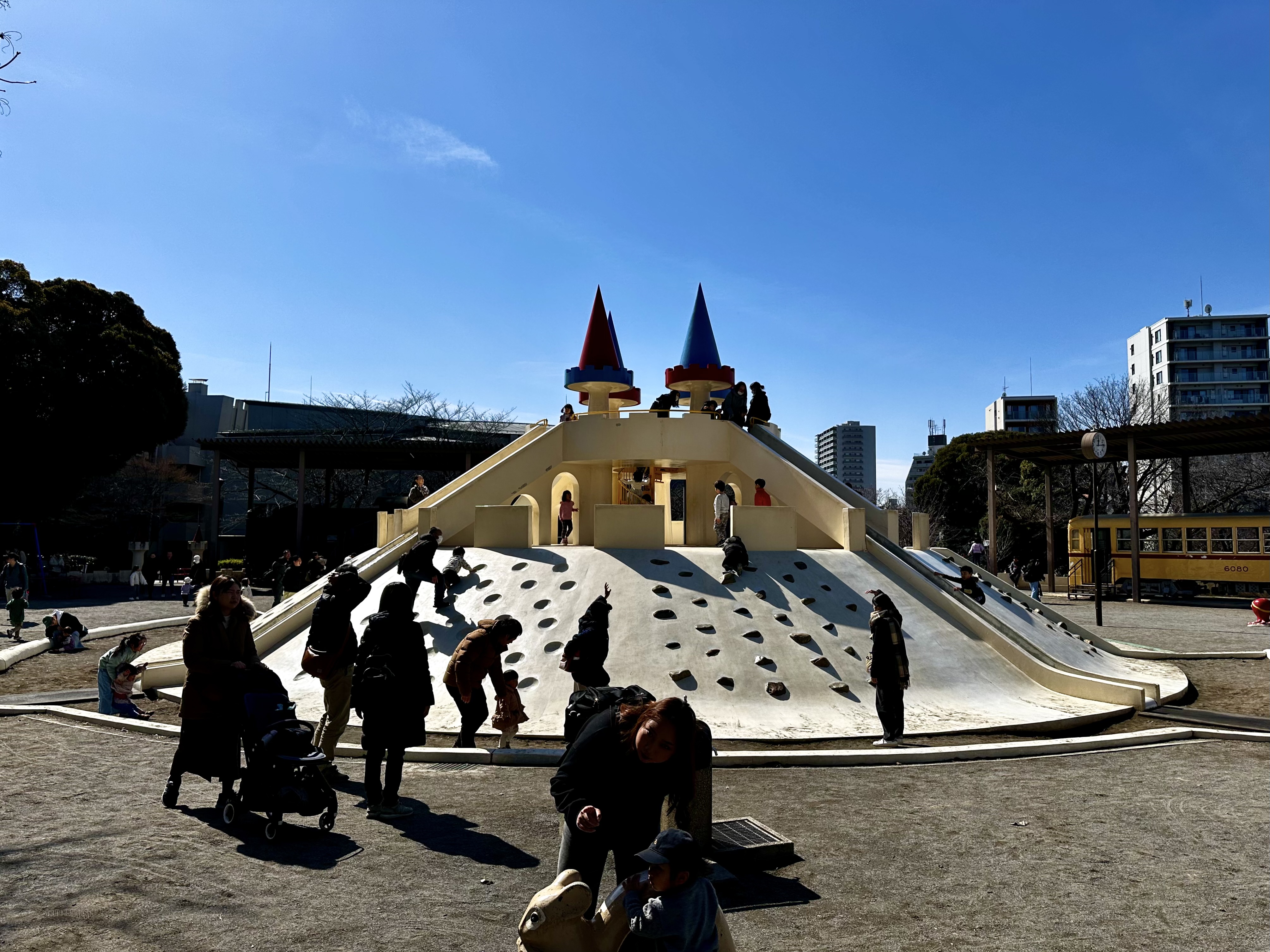 A two story concrete castle play structure in a park in northern Tokyo