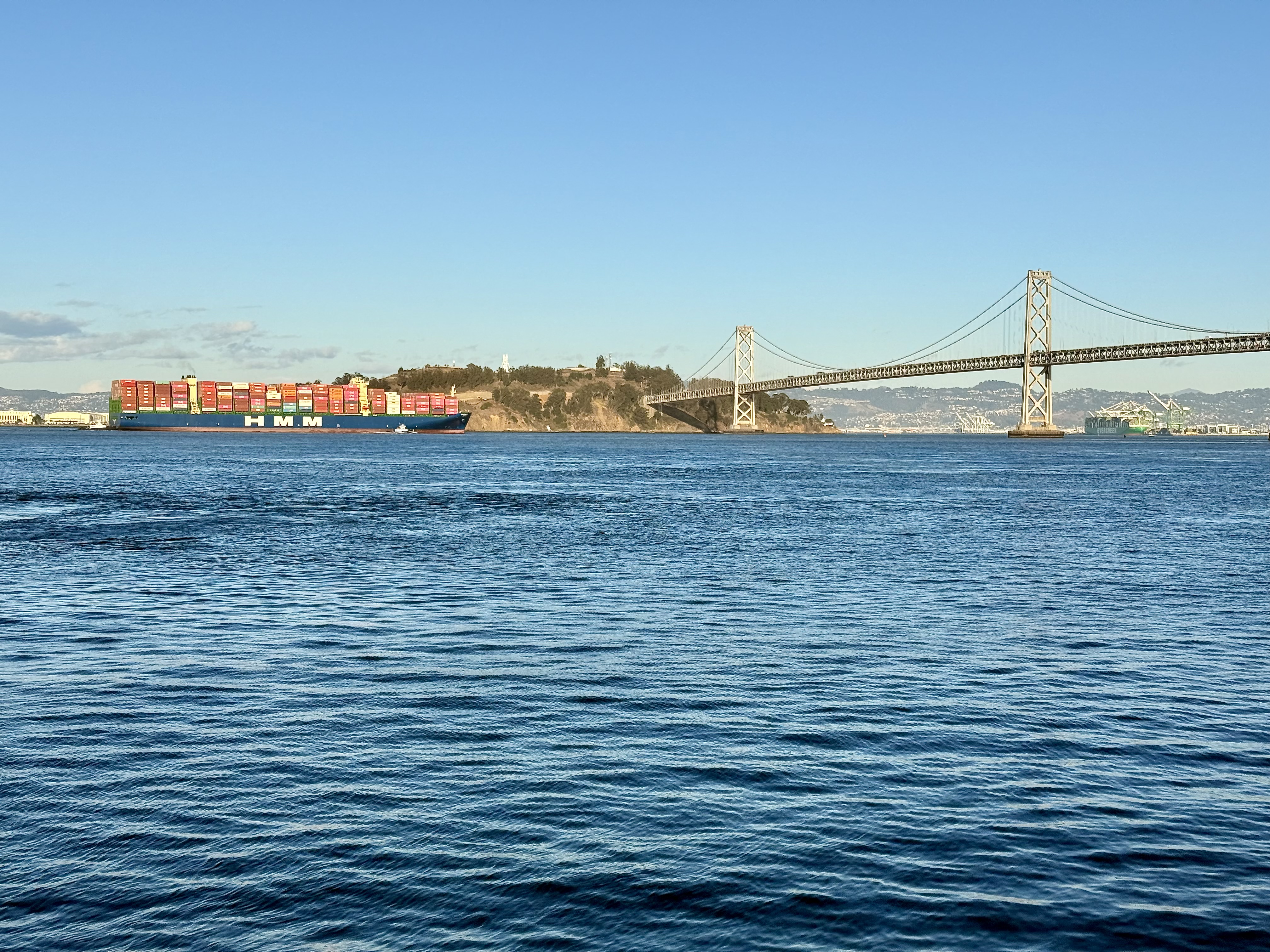 A container ship pulling into San Francisco bay past Treasure Island and the Bay Bridge