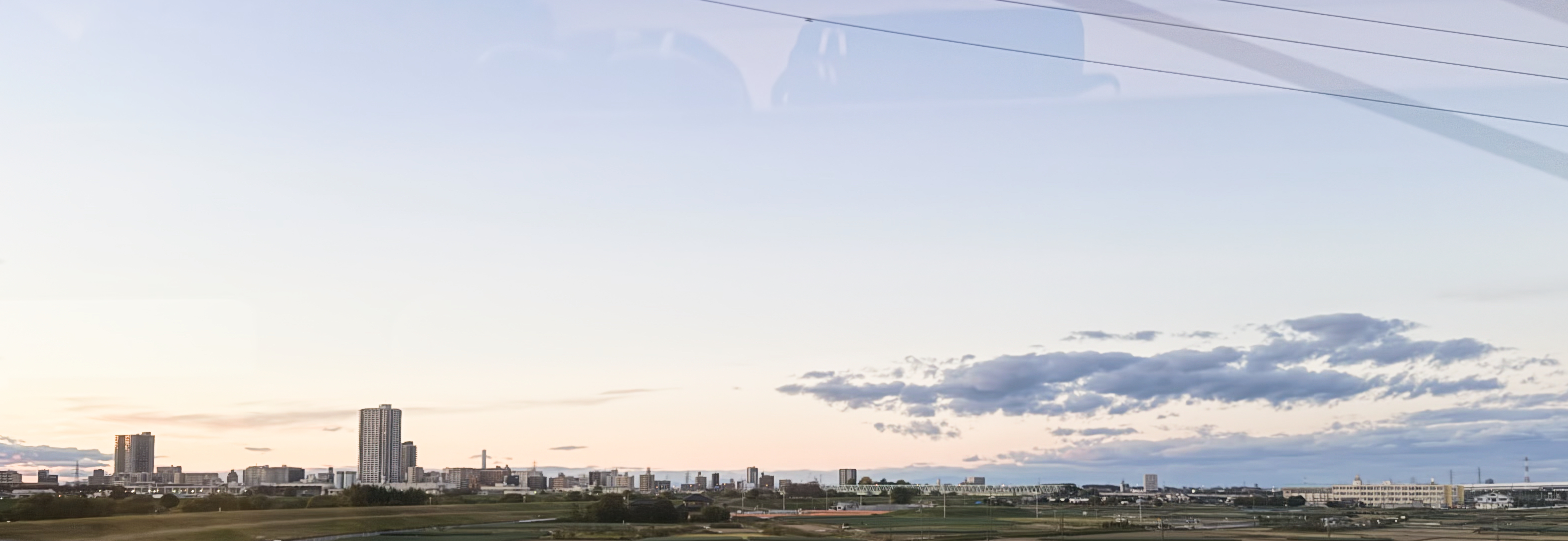 Looking out from the Kesei Skyliner on the way into Tokyo at the evening sky